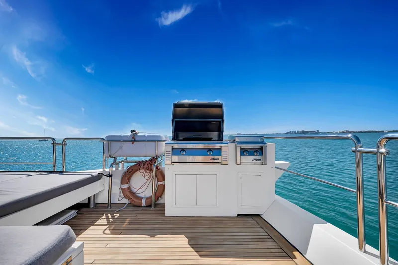 Babieca Yacht Photos Pics Luxury Azimut 105 yacht deck with grill, ocean view, and clear blue sky, 2005 model.