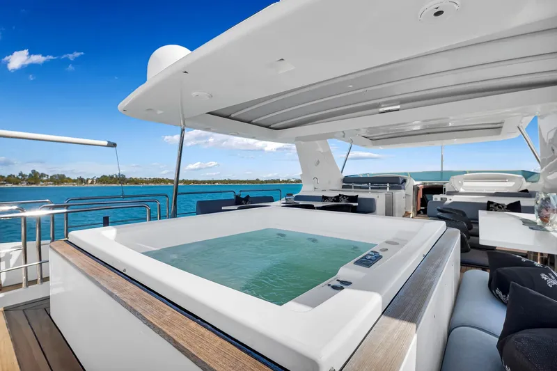 Babieca Yacht Photos Pics Luxurious 2005 Azimut 105 yacht with jacuzzi on deck, overlooking serene blue waters.