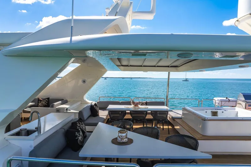 Babieca Yacht Photos Pics Luxurious 2005 Azimut 105 yacht deck with seating, dining area, and ocean view.