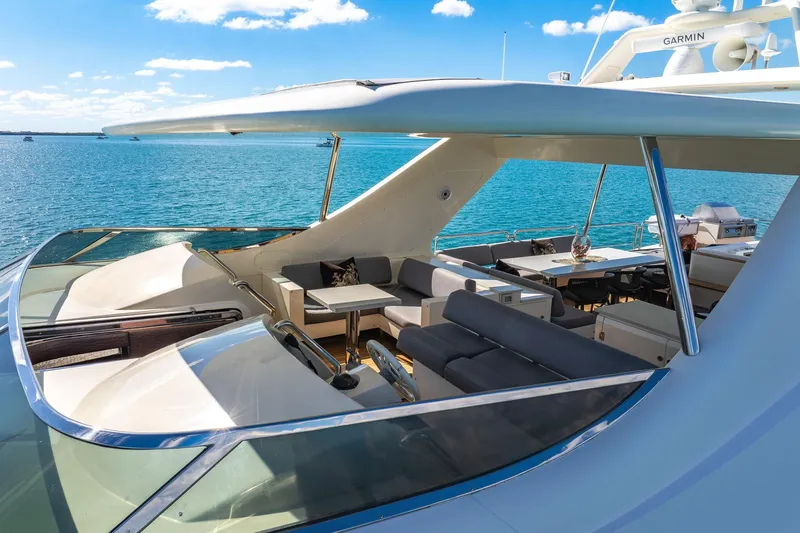 Babieca Yacht Photos Pics Luxurious 2005 Azimut 105 yacht deck with seating, overlooking serene blue waters.