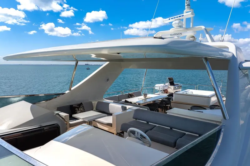 Babieca Yacht Photos Pics Luxurious 2005 Azimut 105 yacht deck with seating, ocean view, and clear blue sky.
