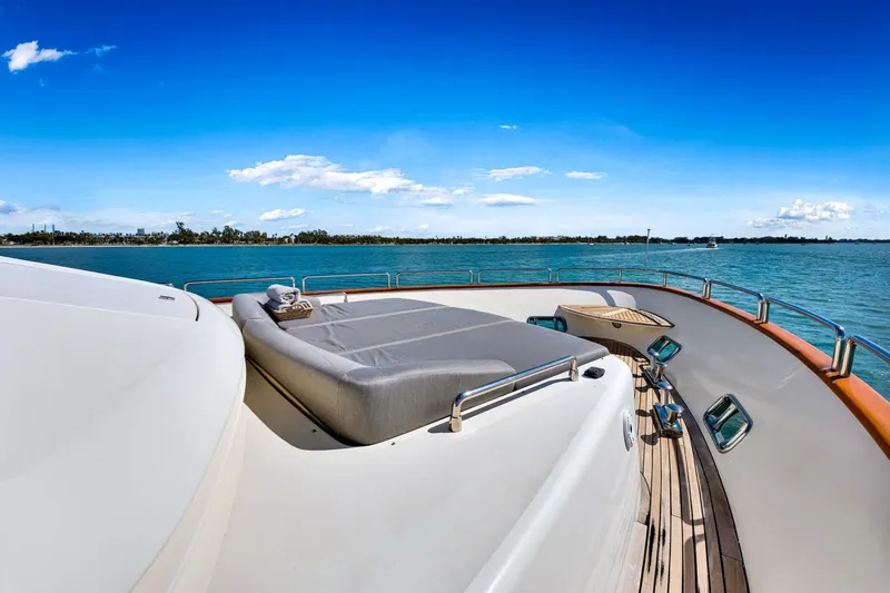 Babieca Yacht Photos Pics Luxury Azimut 105 yacht deck with sunbed, ocean view, clear blue sky.