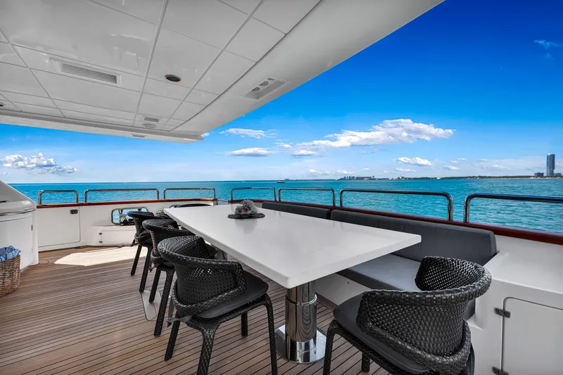 Babieca Yacht Photos Pics Luxurious Azimut 105 yacht deck with dining area, ocean view, and modern seating, 2005 model.