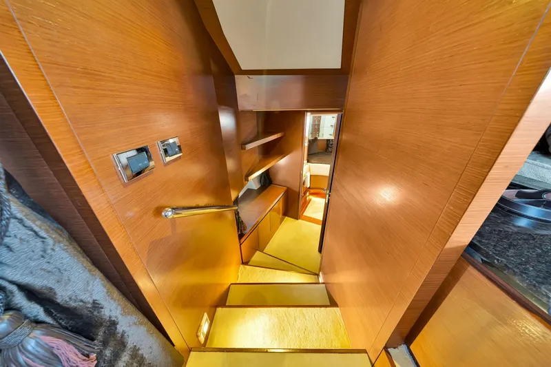 Babieca Yacht Photos Pics Interior staircase of 2005 Azimut 105 yacht with wooden finish and modern design.