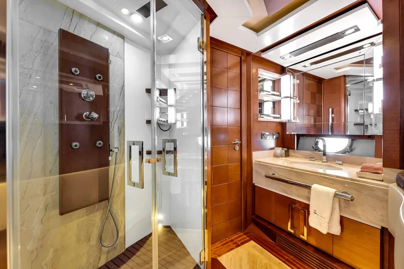 Babieca Yacht Photos Pics Luxurious bathroom in 2005 Azimut 105 yacht with modern shower and elegant wood finishes.