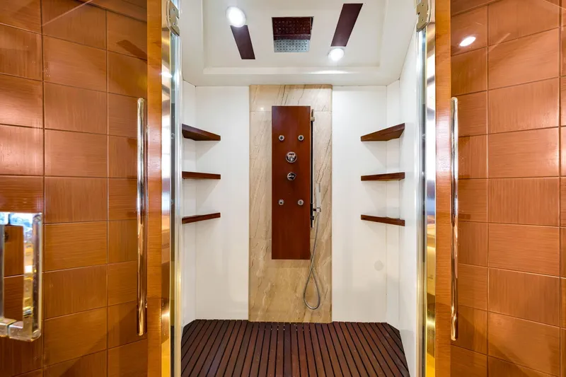 Babieca Yacht Photos Pics Luxurious shower interior on 2005 Azimut 105 yacht, featuring wooden accents and modern fixtures.