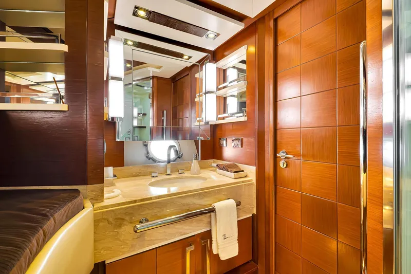 Babieca Yacht Photos Pics Luxurious bathroom interior on 2005 Azimut 105 yacht, featuring elegant wood and marble finishes.