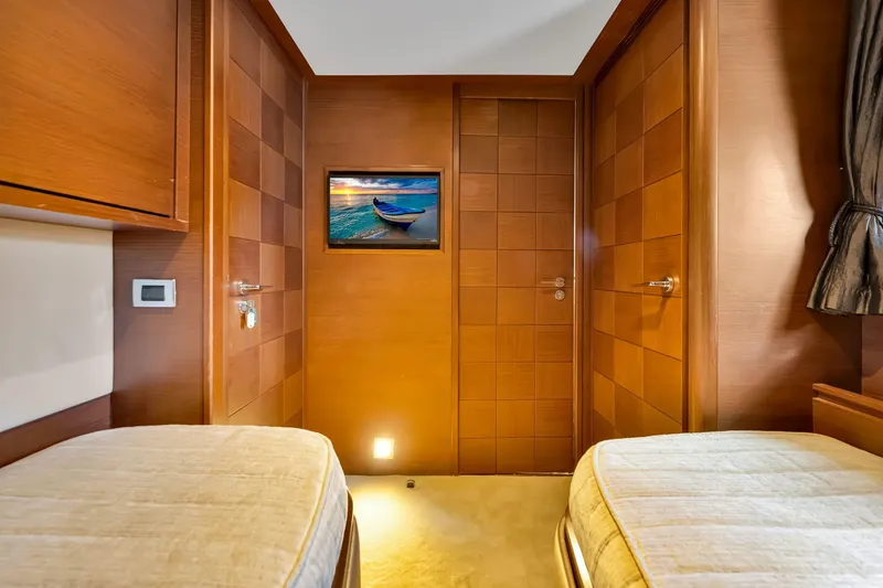 Babieca Yacht Photos Pics Luxurious 2005 Azimut 105 yacht cabin with wooden interior and twin beds.