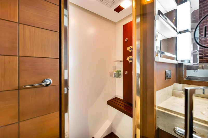 Babieca Yacht Photos Pics Luxurious bathroom interior on 2005 Azimut 105 yacht, featuring wood accents and modern fixtures.