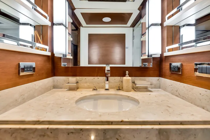 Babieca Yacht Photos Pics Luxurious bathroom on 2005 Azimut 105 yacht with marble countertop and modern fixtures.