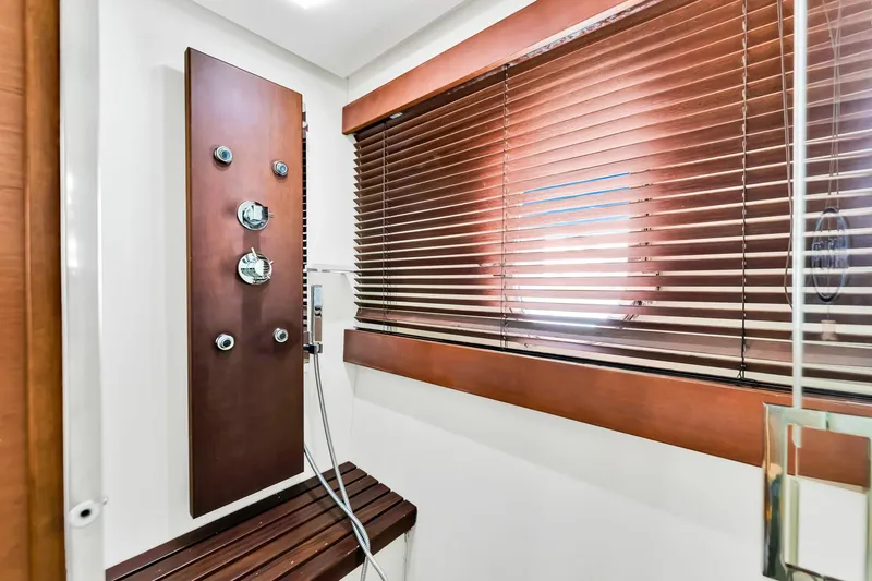Babieca Yacht Photos Pics Luxurious shower area in 2005 Azimut 105 yacht with wooden accents and blinds.
