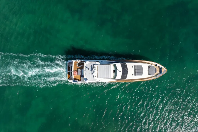 Babieca Yacht Photos Pics Aerial view of 2005 Azimut 105 yacht cruising on clear turquoise water.