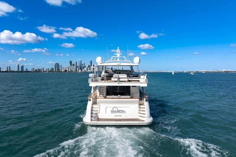 Babieca Yacht Photos Pics Azimut 105 yacht cruising near city skyline under clear blue sky, 2005 model.