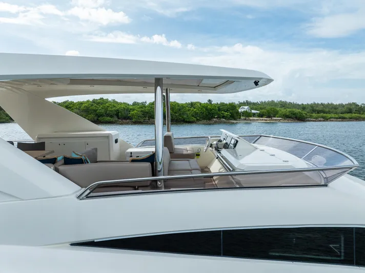 Oceana Yacht Photos Pics Luxury 2015 Prestige 750 yacht with sleek design, cruising near lush green shoreline.