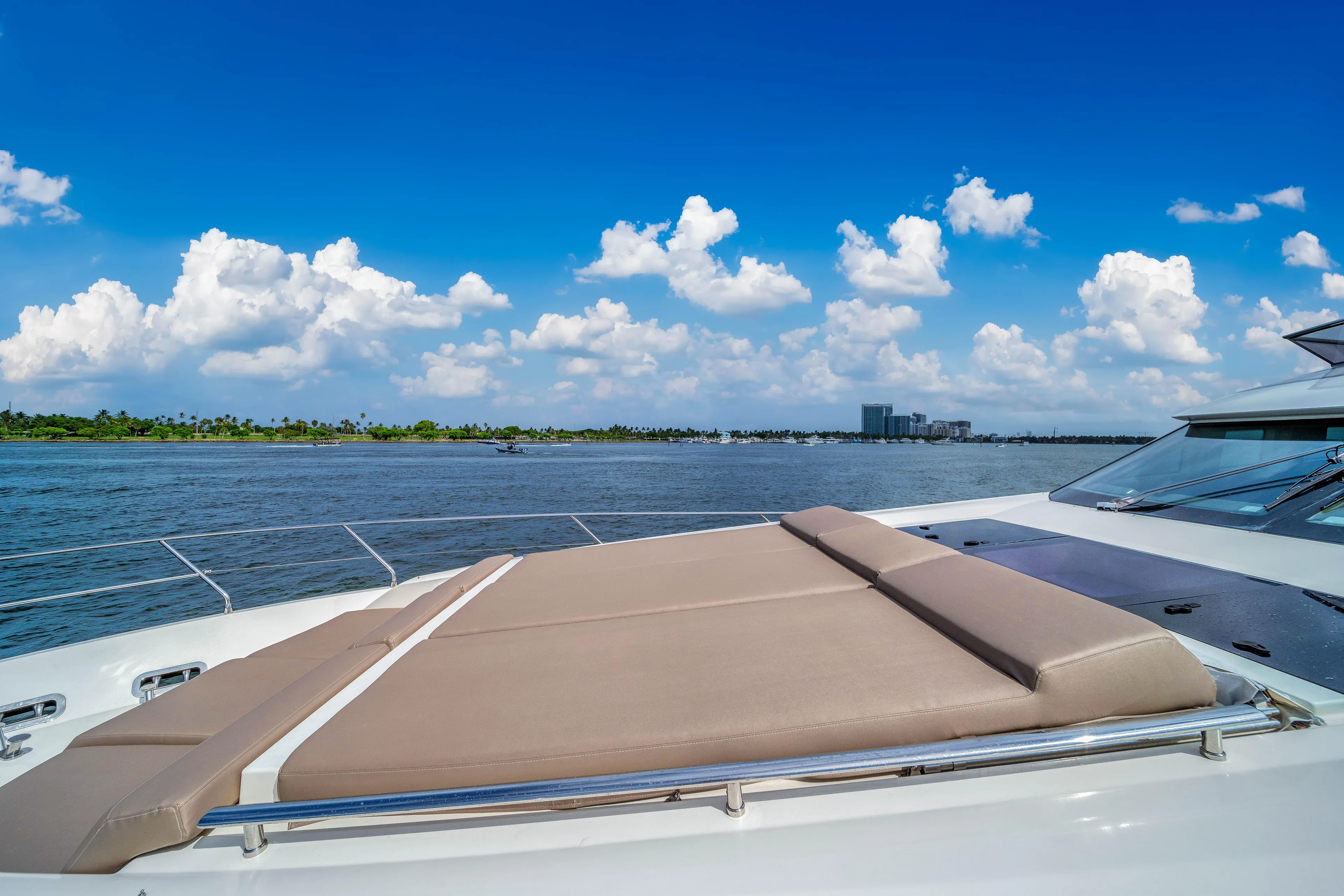 Oceana Yacht Photos Pics 2015 Prestige 750 yacht deck with sunbed, ocean view, and blue sky.