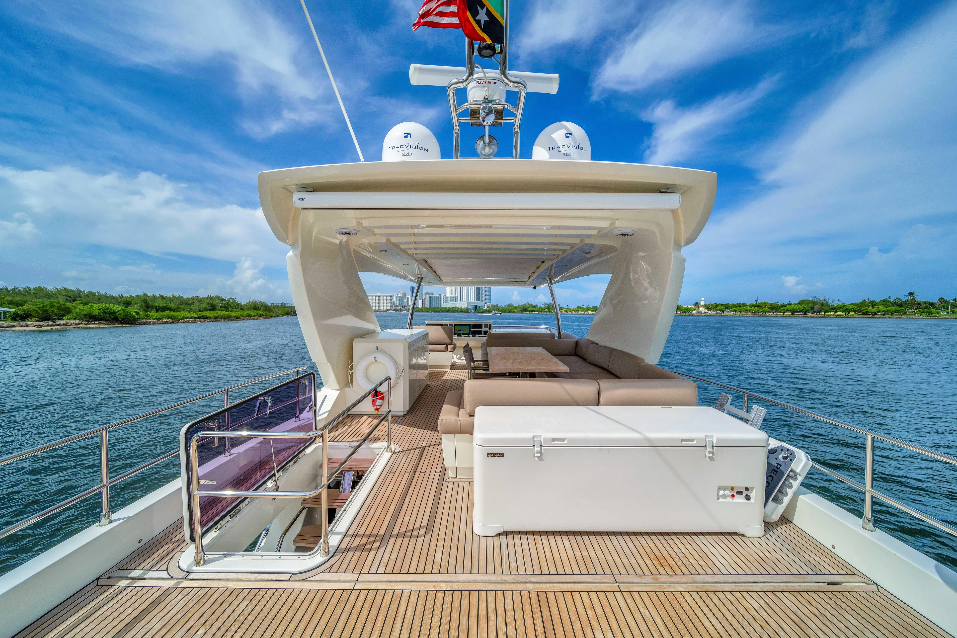 Oceana Yacht Photos Pics Luxurious 2015 Prestige 750 yacht deck with seating, under a clear blue sky.