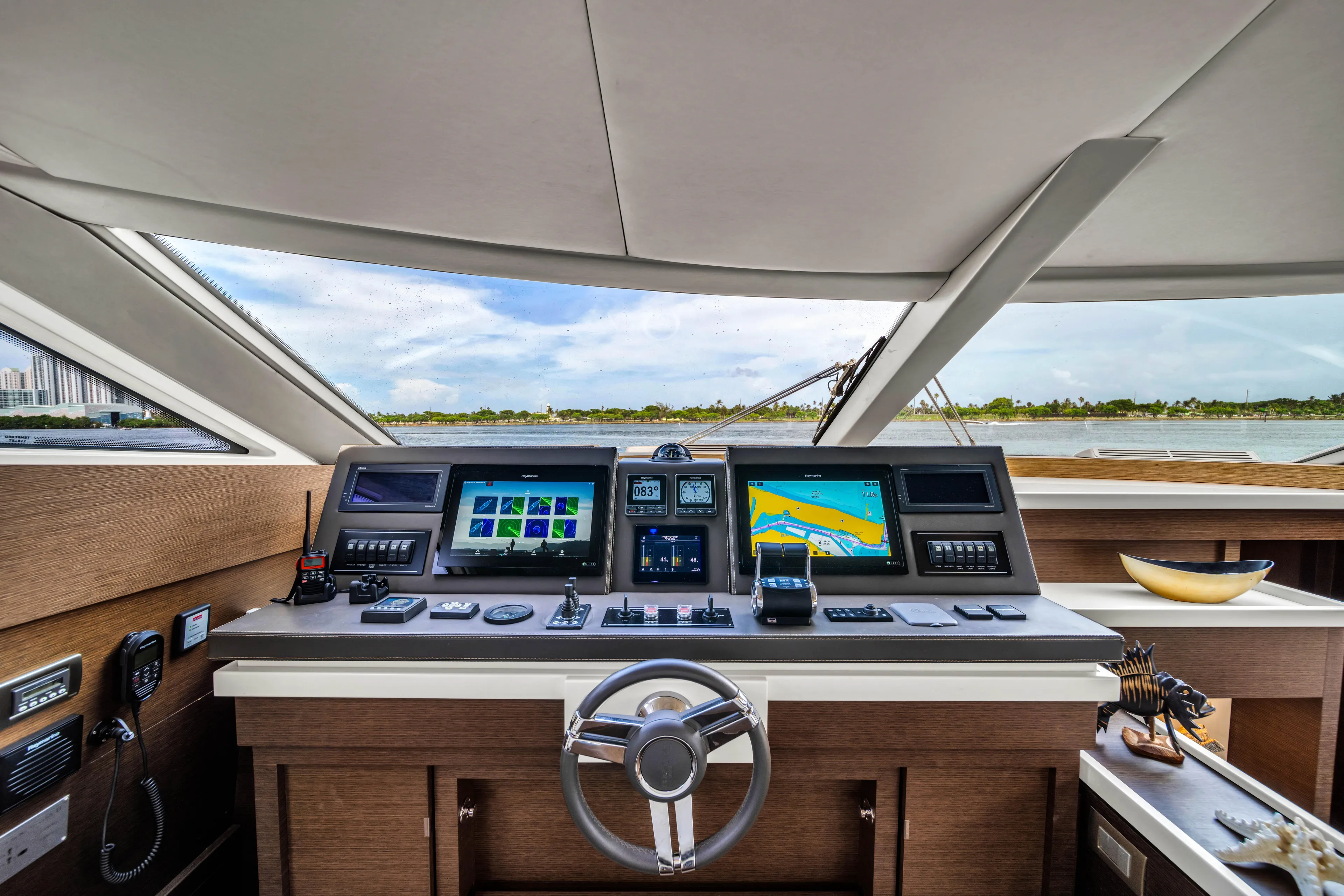 Oceana Yacht Photos Pics Cockpit of 2015 Prestige 750 yacht with navigation screens and steering wheel.