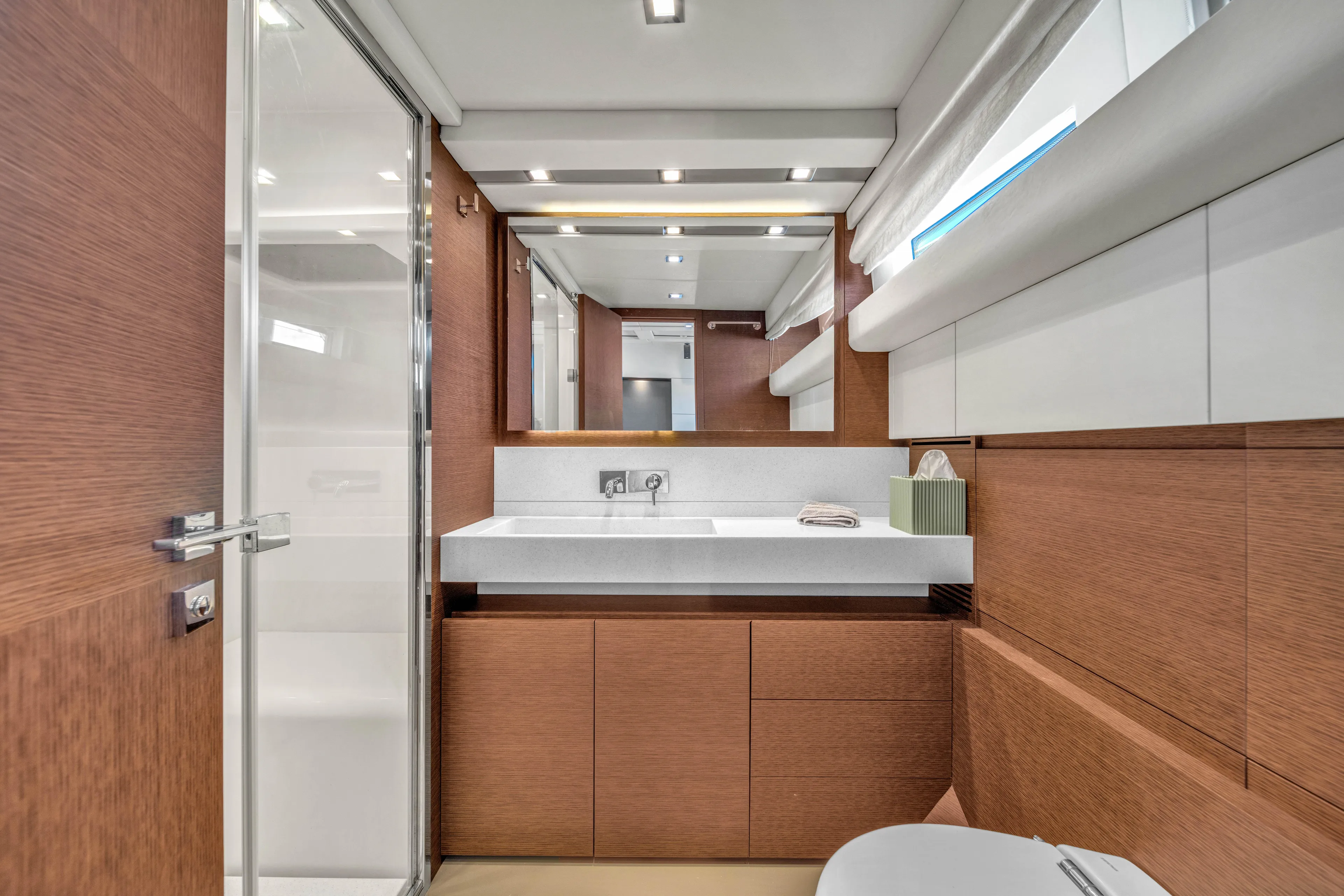Oceana Yacht Photos Pics Luxurious bathroom interior of 2015 Prestige 750 yacht with modern fixtures and wood accents.