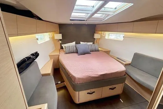 Second Wind Yacht Photos Pics Luxurious cabin interior of 2017 Jeanneau 54 yacht with cozy bed and seating.