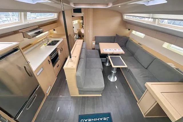 Second Wind Yacht Photos Pics Luxurious interior of 2017 Jeanneau 54 yacht with modern kitchen and spacious seating area.