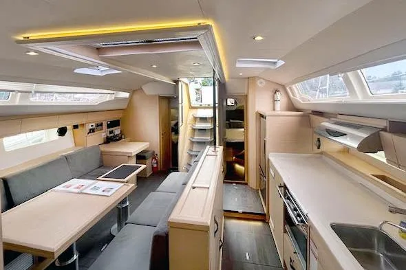 Second Wind Yacht Photos Pics Interior of 2017 Jeanneau 54 yacht, featuring modern kitchen and spacious seating area.