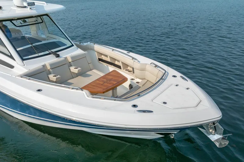 Blue Skies Yacht Photos Pics 2019 Boston Whaler 350 EX REALM boat on water, featuring spacious seating and sleek design.