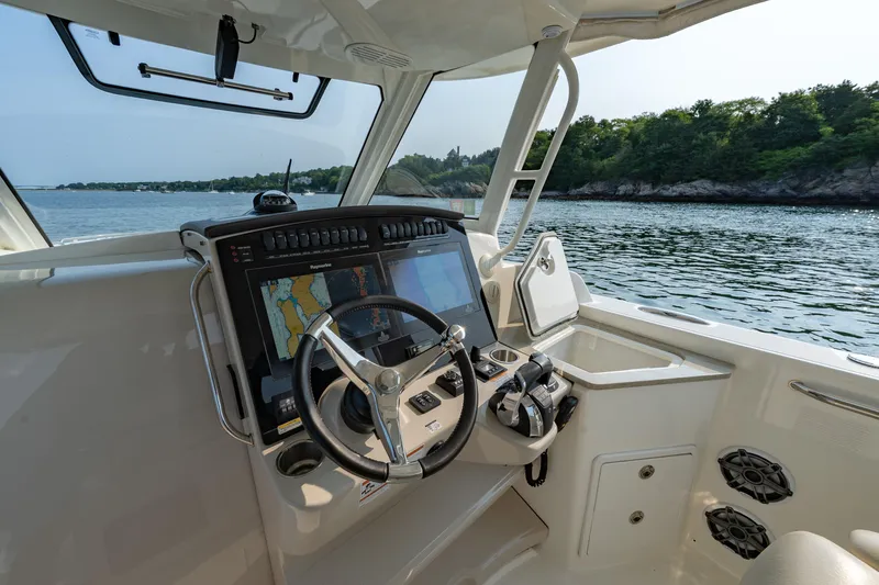 Blue Skies Yacht Photos Pics 2019 Boston Whaler 350 EX REALM helm with navigation system on calm waters.