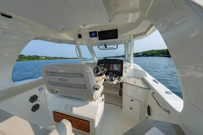 Blue Skies Yacht Photos Pics 2019 Boston Whaler 350 EX REALM boat interior with navigation system on calm water.