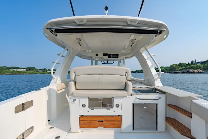 Blue Skies Yacht Photos Pics 2019 Boston Whaler 350 EX REALM boat interior with seating and ocean view.