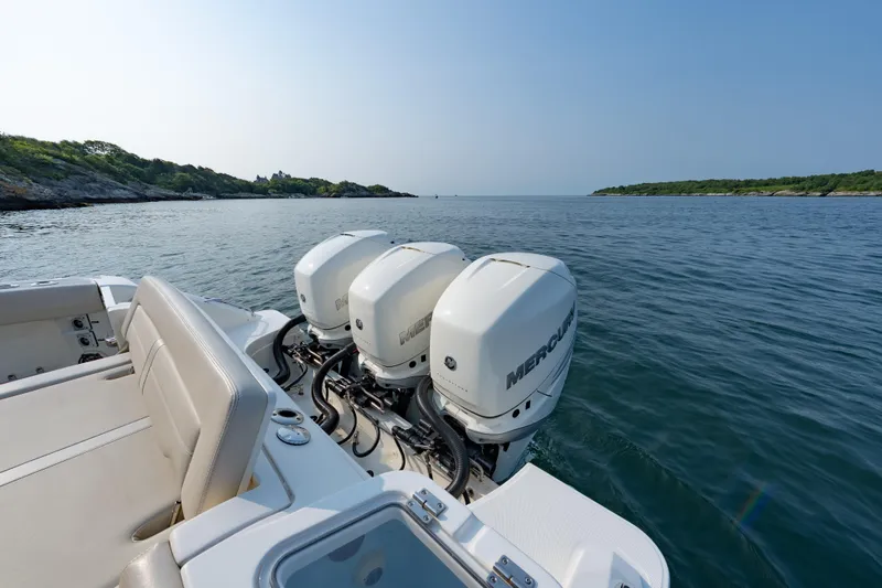 Blue Skies Yacht Photos Pics 2019 Boston Whaler 350 EX REALM with triple Mercury engines on calm water.