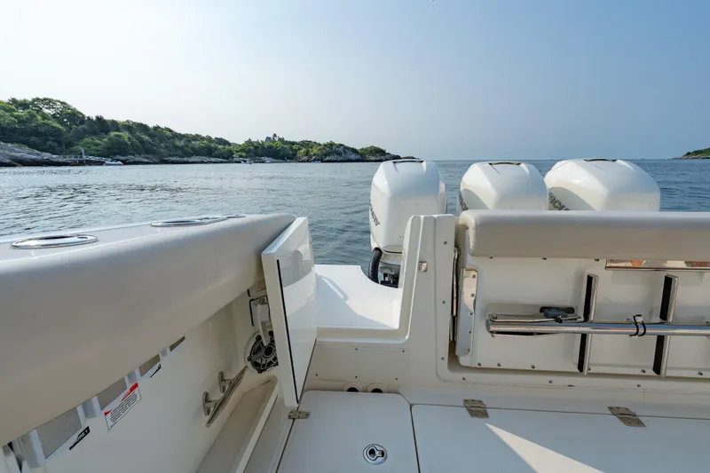 Blue Skies Yacht Photos Pics 2019 Boston Whaler 350 EX REALM boat with triple engines on calm water.