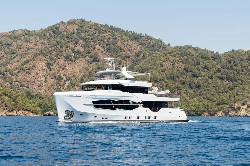 Numarine 32xp Yacht Photos Pics Numarine 32XP 2026 yacht cruising near scenic coastline with lush hills.