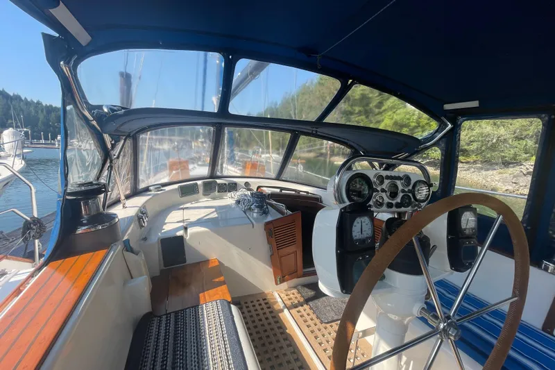 Sun Dazzler Yacht Photos Pics Cockpit of 1981 Mariner 48 yacht with steering wheel and navigation instruments.
