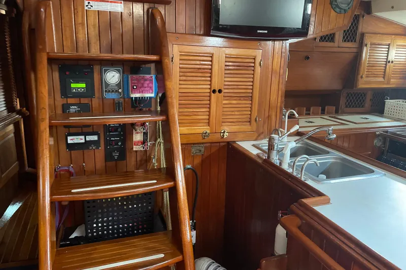 Sun Dazzler Yacht Photos Pics Interior of 1981 Mariner 48 yacht with wooden cabinetry and modern kitchen amenities.