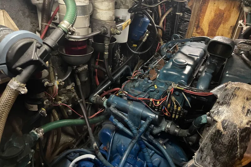 Sun Dazzler Yacht Photos Pics Engine room of a 1981 Mariner 48 boat with visible wiring and components.