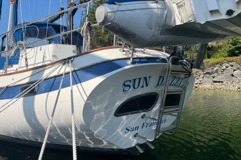 Sun Dazzler Yacht Photos Pics 1981 Mariner 48 sailboat "Sun Dazzler" docked, featuring blue and white design.