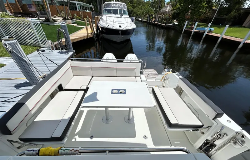 Rosie 3 Yacht Photos Pics 2022 Jeanneau Leader 10.5 WA Series 2 boat docked, featuring spacious seating and table.