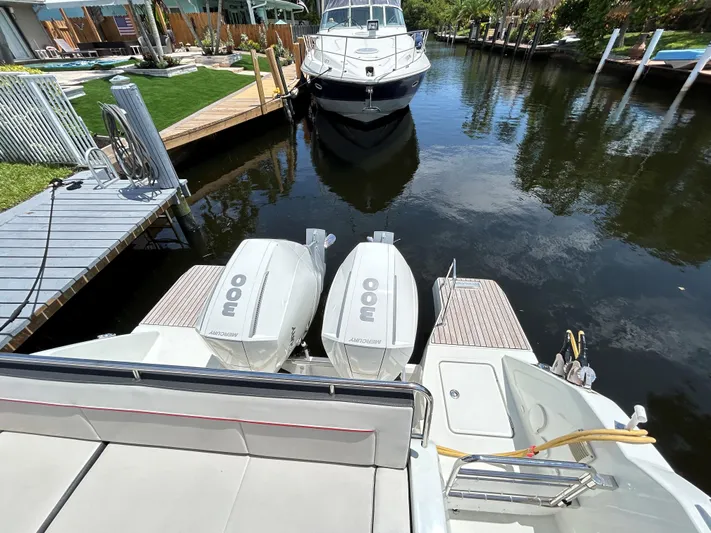 Rosie 3 Yacht Photos Pics 2022 Jeanneau Leader 10.5 WA Series 2 with twin Mercury 300 engines docked in a canal.
