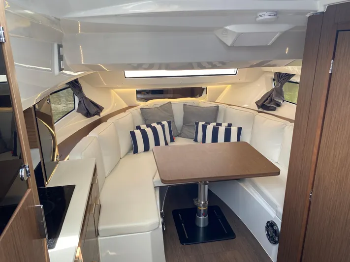 Rosie 3 Yacht Photos Pics Interior of 2022 Jeanneau Leader 10.5 WA Series 2 with cozy seating and table.