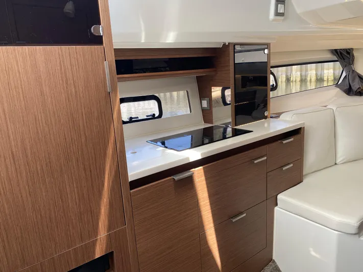 Rosie 3 Yacht Photos Pics Interior of 2022 Jeanneau Leader 10.5 WA Series 2, featuring modern kitchen and seating area.