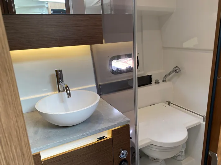 Rosie 3 Yacht Photos Pics Modern bathroom in 2022 Jeanneau Leader 10.5 WA Series 2 boat, featuring sink and toilet.