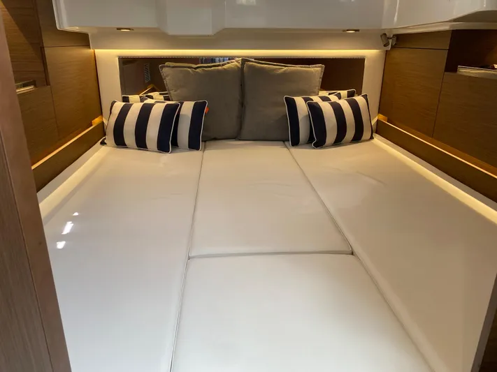 Rosie 3 Yacht Photos Pics Interior cabin of 2022 Jeanneau Leader 10.5 WA Series 2 with striped cushions.