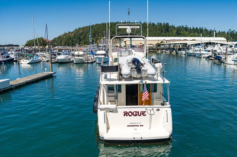 Rogue Yacht Photos Pics 2007 North Pacific NP42 Pilothouse boat docked in a marina, surrounded by other vessels.