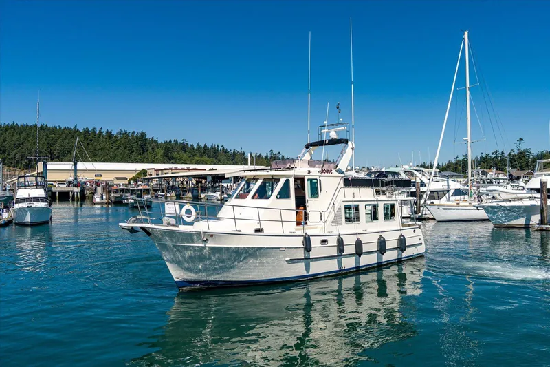 Rogue Yacht Photos Pics 2007 North Pacific NP42 Pilothouse yacht docked in a marina under clear blue skies.
