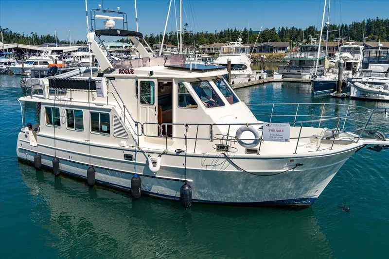 Rogue Yacht Photos Pics 2007 North Pacific NP42 Pilothouse yacht for sale, docked in a marina.