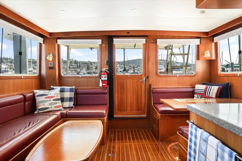 Rogue Yacht Photos Pics Luxurious 2007 North Pacific NP42 Pilothouse interior with elegant wood finish and plush seating.