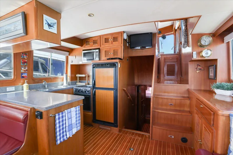 Rogue Yacht Photos Pics Interior of 2007 North Pacific NP42 Pilothouse with wood finish and modern amenities.