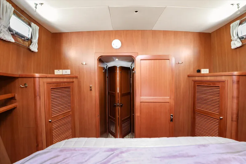 Rogue Yacht Photos Pics Interior of 2007 North Pacific NP42 Pilothouse with wooden cabinetry and cozy design.