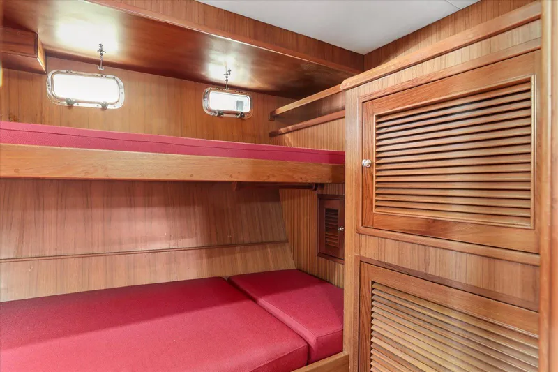 Rogue Yacht Photos Pics 2007 North Pacific NP42 Pilothouse cabin with wooden interior and red bunk beds.