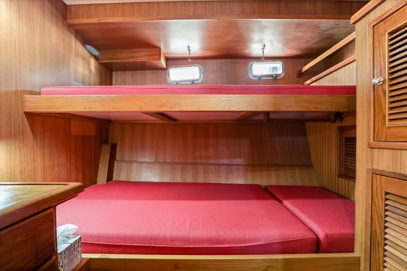 Rogue Yacht Photos Pics Cozy cabin with red bunk beds in 2007 North Pacific NP42 Pilothouse.